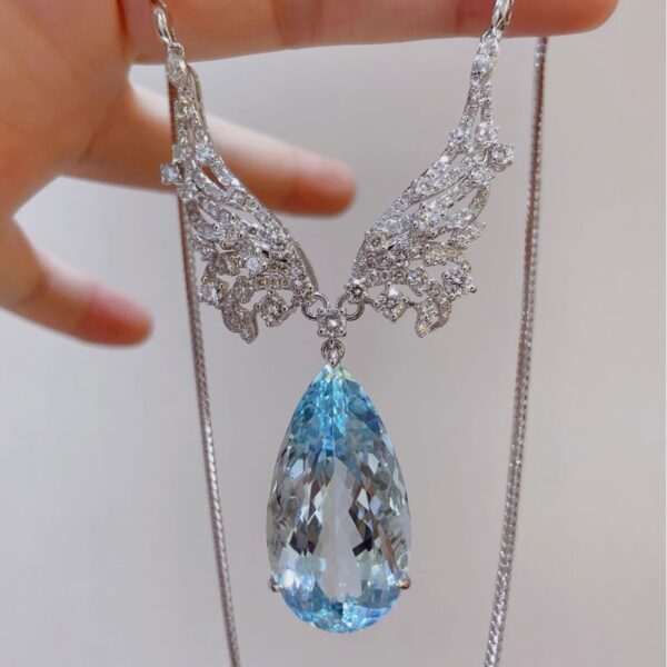 #209 Natural Santa Maria Aquamarine Necklace features a 38.98-carat 18k gold main stone set with diamonds